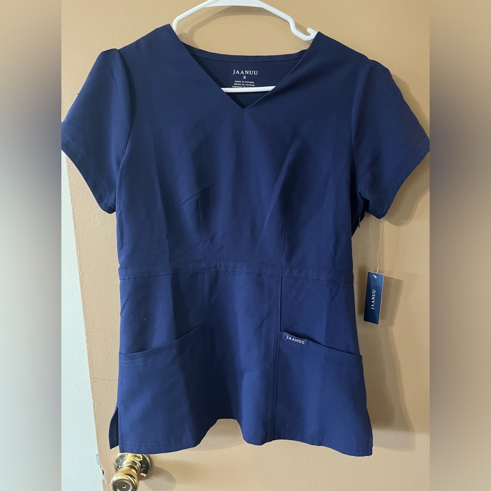 Jaanuu Peplum Scrub Top. Navy Blue Size S. New with tags